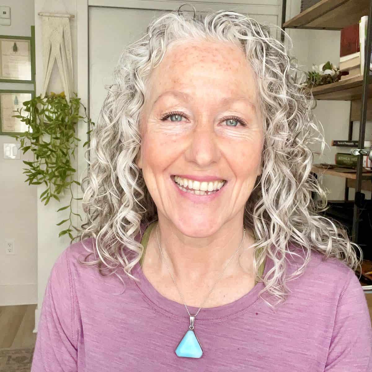 Andrea Beaman, holistic health coach and herbalist, smiling in her kitchen